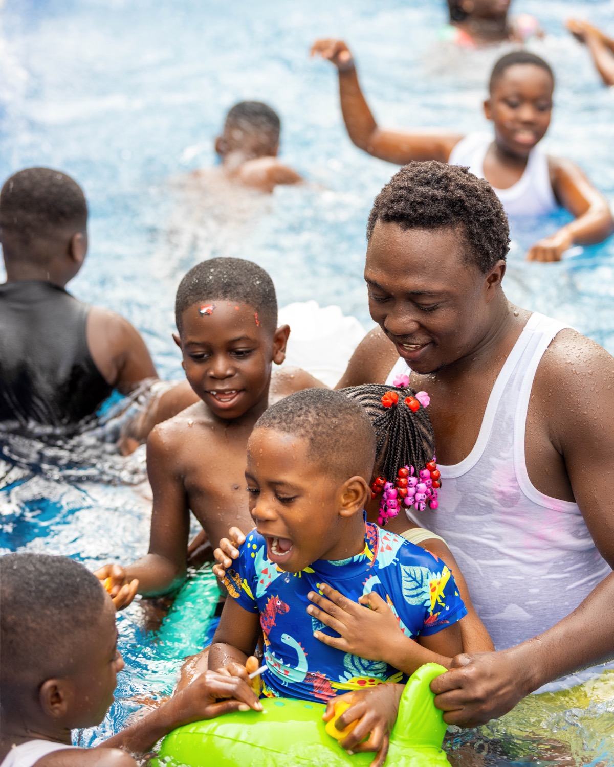 Children enjoying a supervised swimming activity with adult support