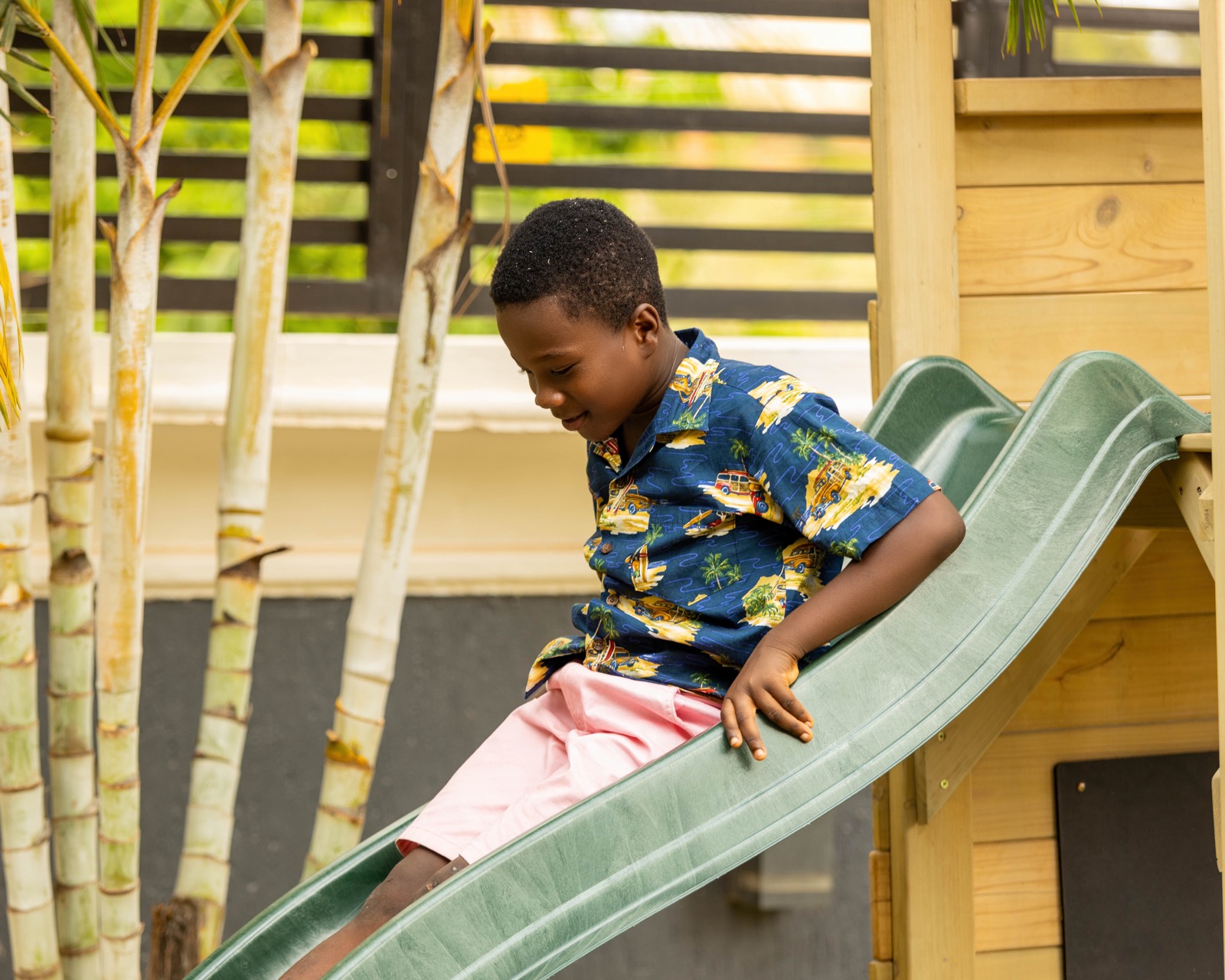 Young HoneyBerry learner enjoying supervised play on a slide